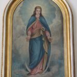 The picture depicts the Virgin Mary on an early 20th century painting (the painter is unknown). It is exhibited in the Greek Catholic Cathedral of Hajdúdorog, Hungary. This painting decorates the Western wall of the Southern side-nave. It represents the typical symbols of the Blessed Virgin: the crescent under her feet that symbolizes Mary's chastity and the sunbeams that appear as a halo around the Virgin Mother's head.