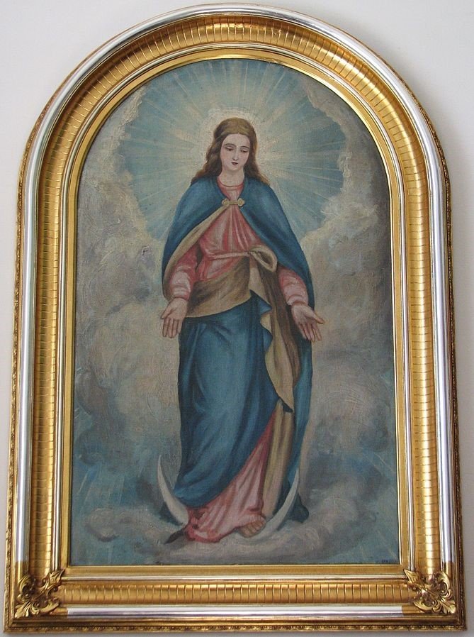 The picture depicts the Virgin Mary on an early 20th century painting (the painter is unknown). It is exhibited in the Greek Catholic Cathedral of Hajdúdorog, Hungary. This painting decorates the Western wall of the Southern side-nave. It represents the typical symbols of the Blessed Virgin: the crescent under her feet that symbolizes Mary's chastity and the sunbeams that appear as a halo around the Virgin Mother's head.